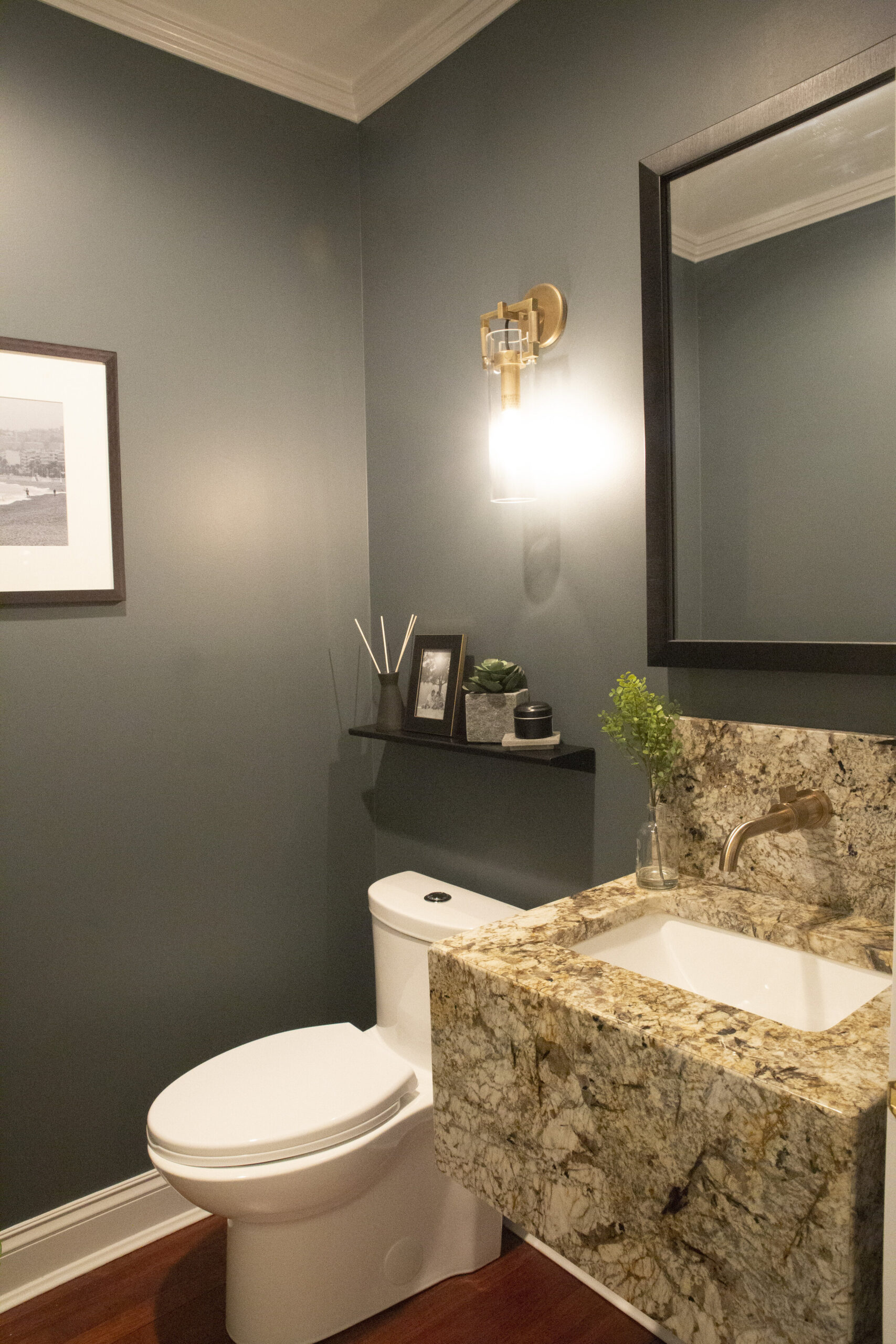 Customized powder room with granite countertop.